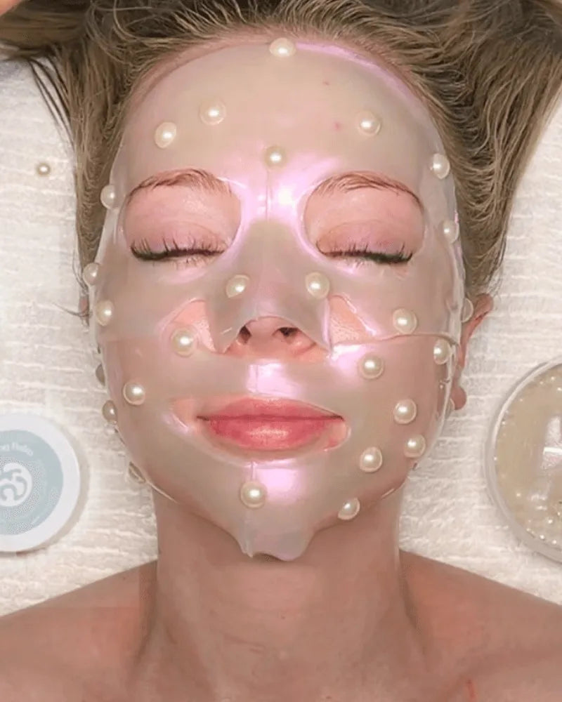 A guest resting with eyes closed under a pearl-studded jelly mask during The Boho Ritual